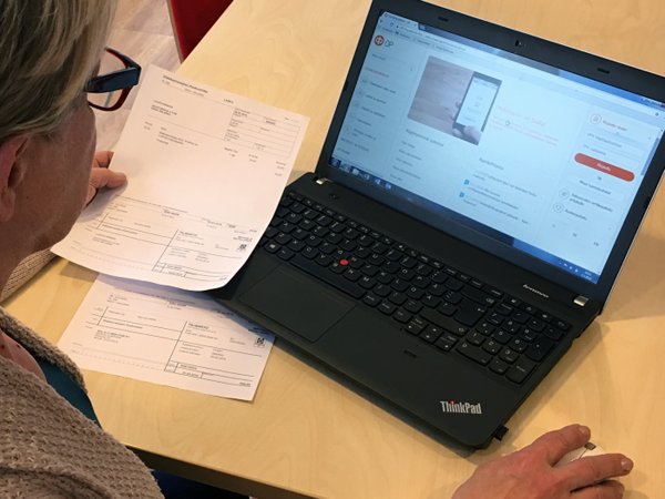 Ihminen kannettavan tietokoneen äärellä käyttämässä verkkopankkipalveluja.